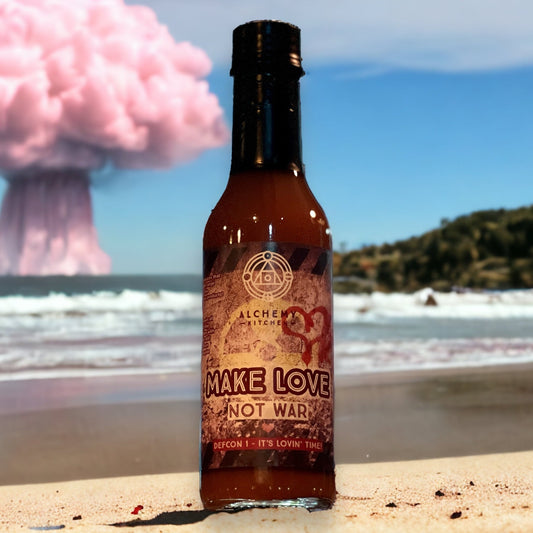 bottle of alchemy kitchen make love not war on beach with pink mushroom cloud in the background